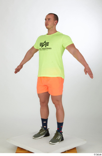 Joel a-pose dressed green sneakers orange shorts sports standing whole…